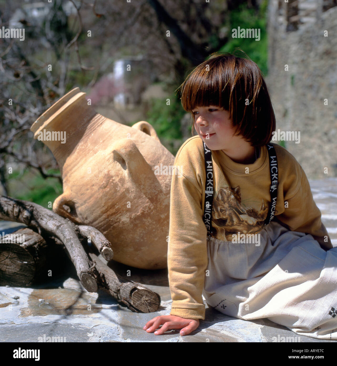 A Spanish girl sits outside her house in Capileira, the highest Alpujarran Village in the Sierra Nevada Mountains in Spain Stock Photo