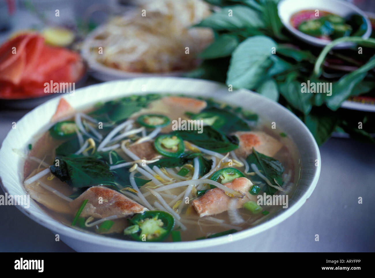 bowl of Pho, traditional Vietnamese noodle soup with sliced beef, chili
