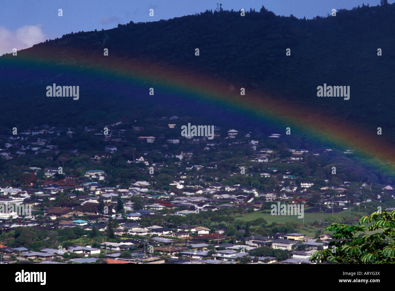View of the houses in beautiful Manoa valley with rainbow Stock Photo