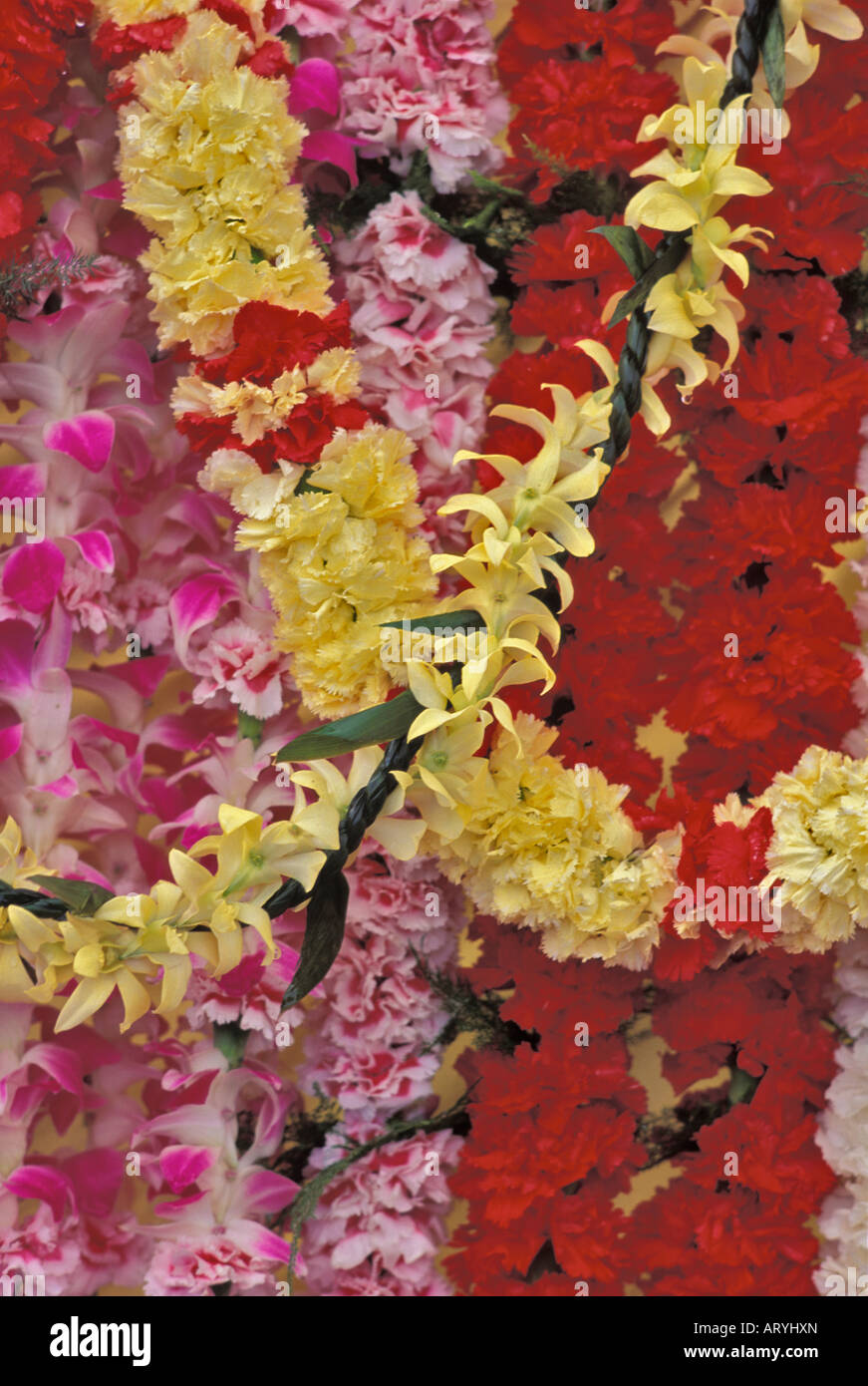 Carnation and orchids leis for sale at an outdoor display during a high