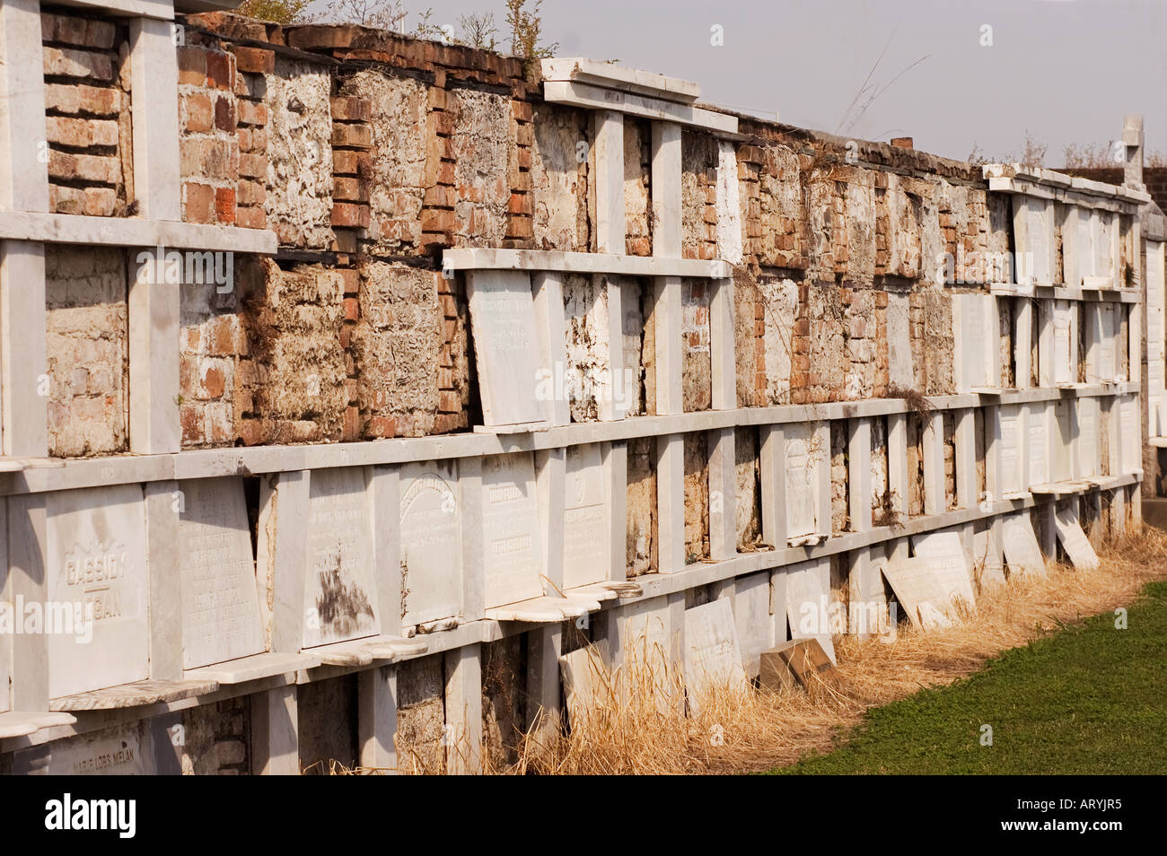 An aisle of 19th century brick and marble vault tombs in Greenwood
