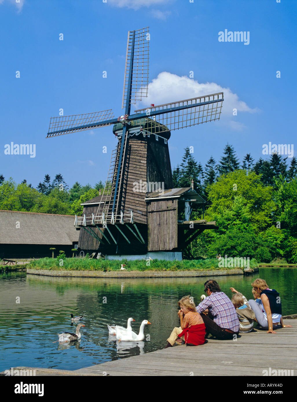 Windmill and a family visiting Openair Museum Arnheim Netherlands Stock Photo