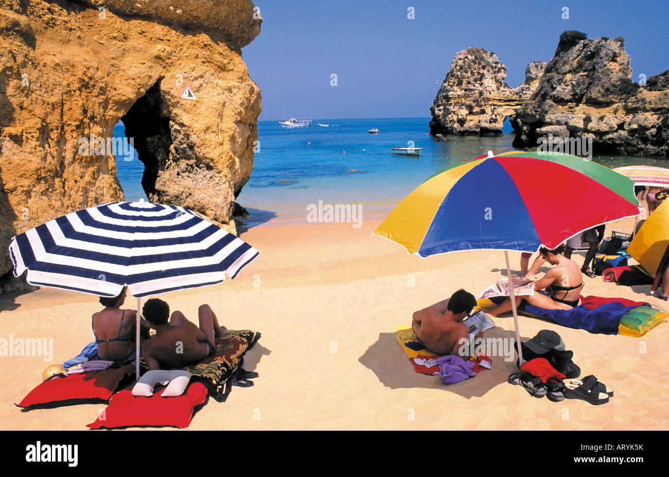 Tourists taking sun at Praia Dona Ana, Lagos, Algarve, Portugal Stock Photo