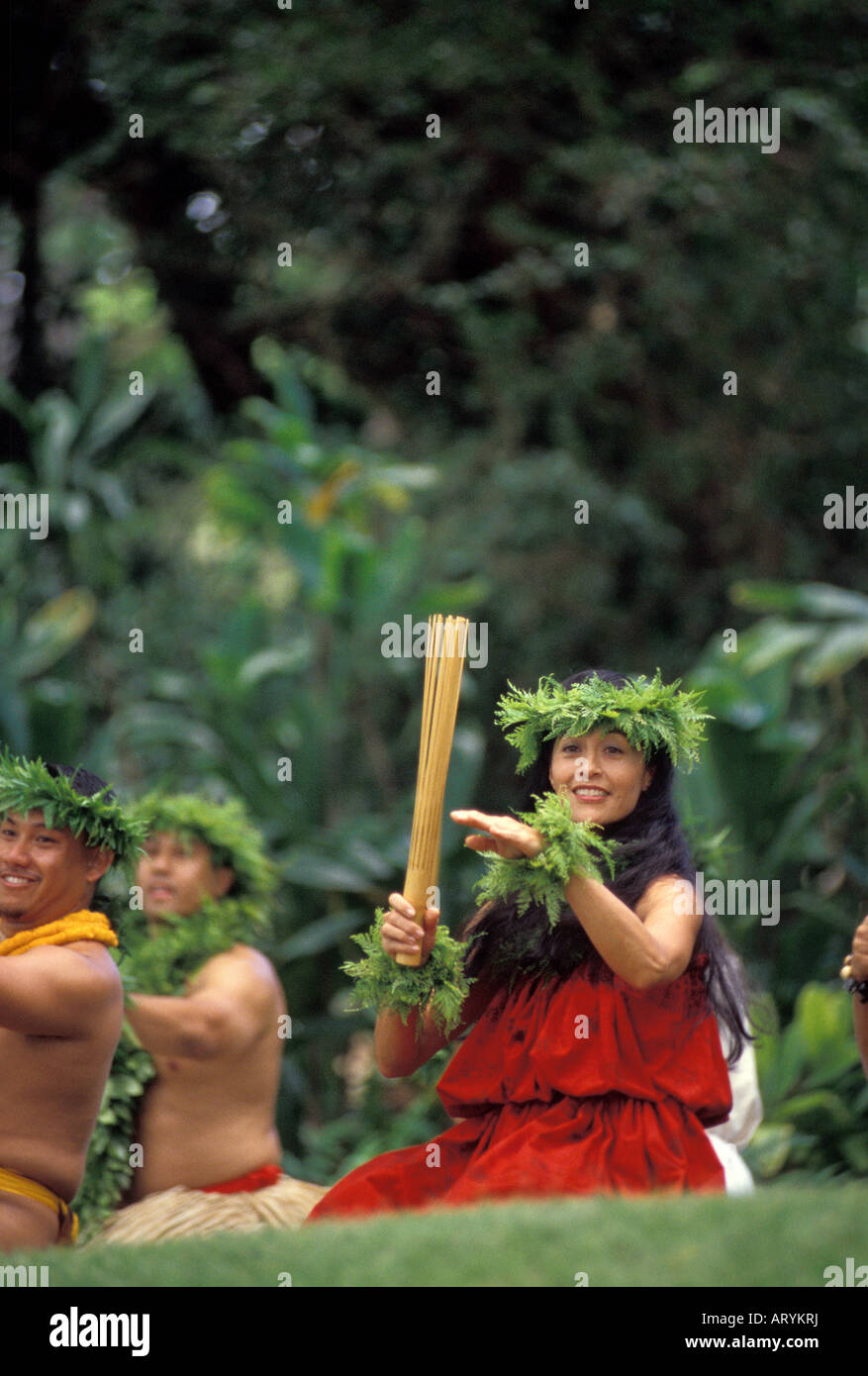 Woman with bamboo puili hula implement at Prince Lot Hula Festival. Moanalua Gardens, Oahu Stock Photo