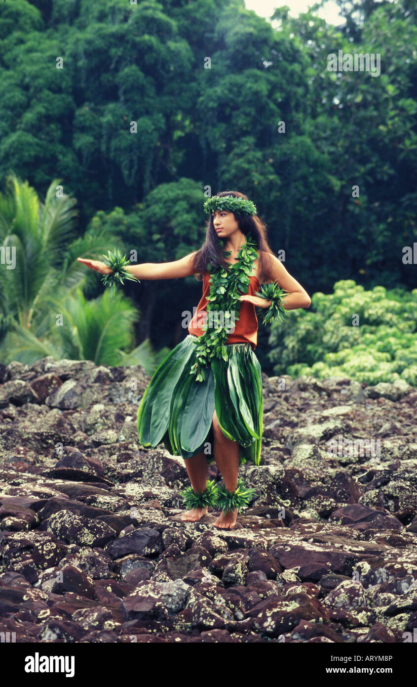 Young hula dancer in ti leaf skirt at Hawaiian heiau ( temple site