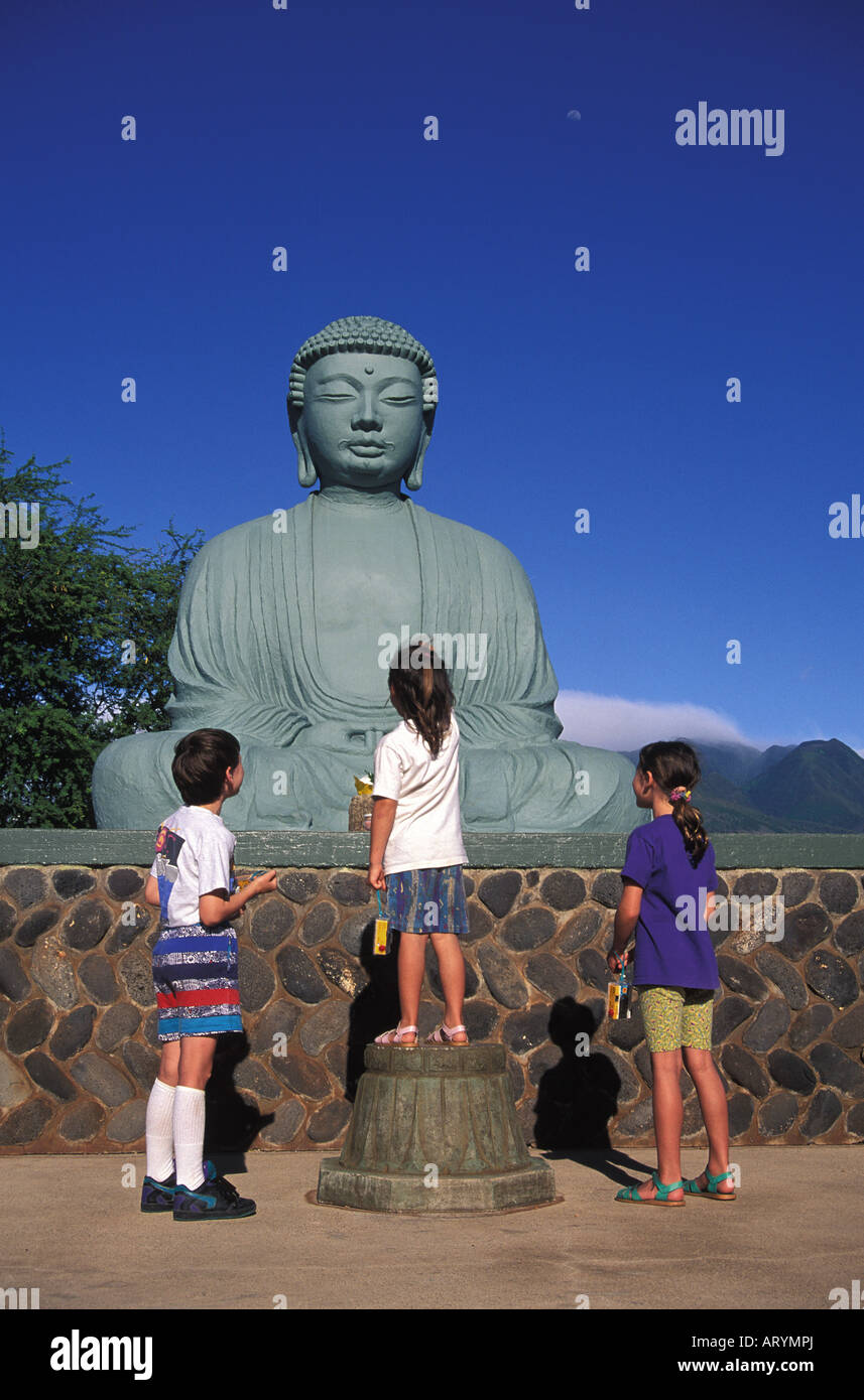 Lahaina jodo mission statue with three children looking up observing Stock Photo