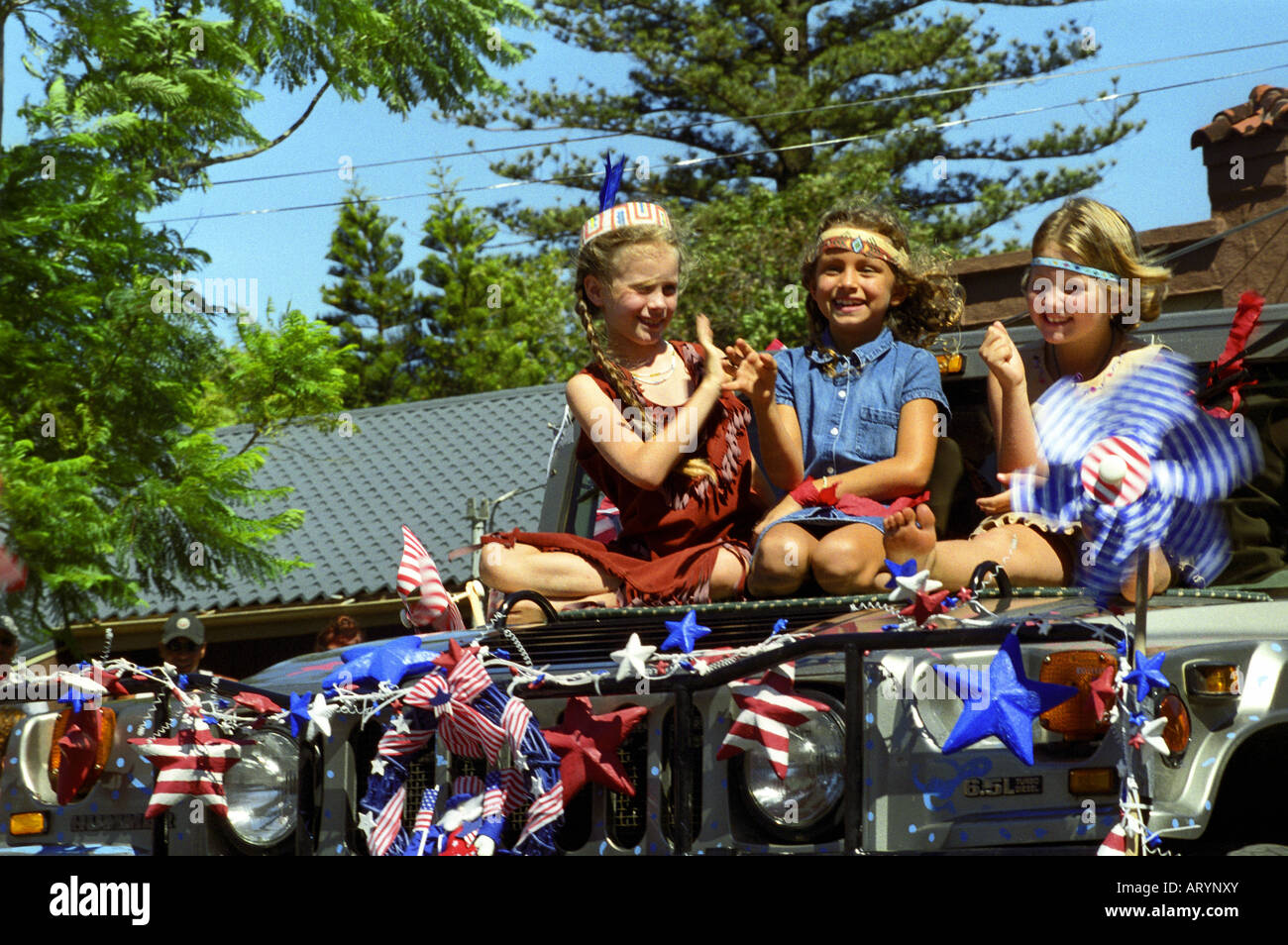 Young girls on float enjoying the annual Fourth of July Makawao Rodeo Parade in the upcountry town of Makawao. Maui's cowboy or Stock Photo