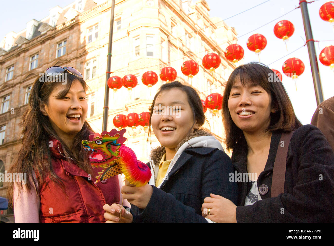 Three women on the streets of London in Chinatown to celebrate the Chinese New Year 2008 - Year of the rat Stock Photo