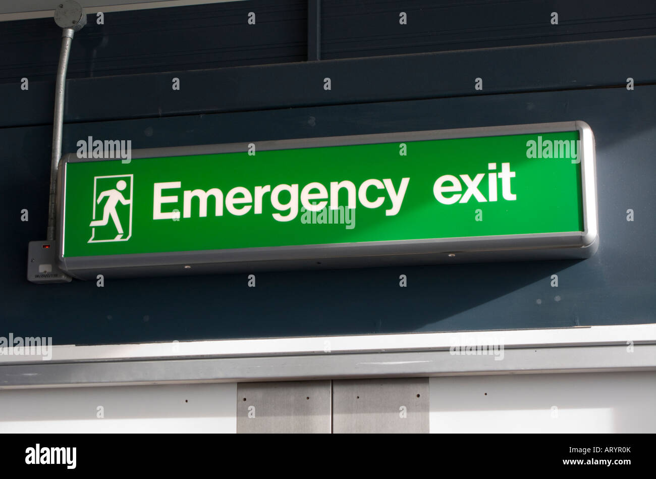 Emergency exit sign in Gatwick airport Stock Photo