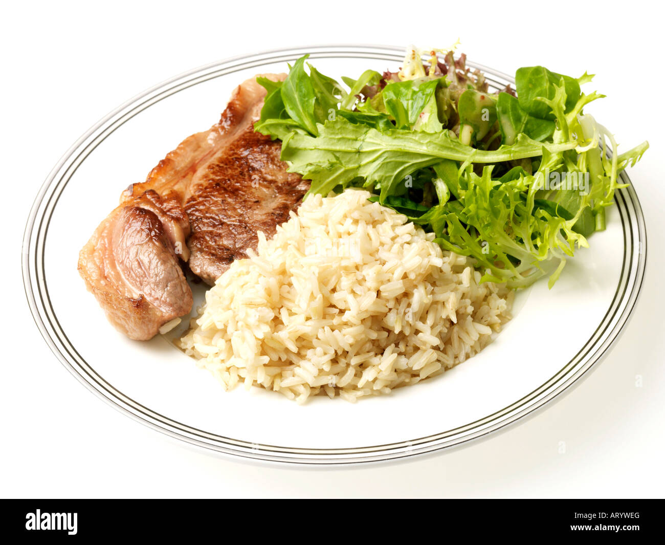 Fresh Lean Rump Beef Steak With Brown Rice and Salad Isolated Against A White Background With A Clipping Path And No People Stock Photo