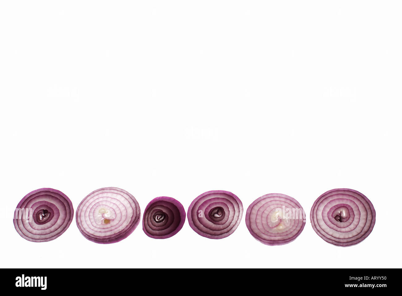 Red onion slices against white background Stock Photo