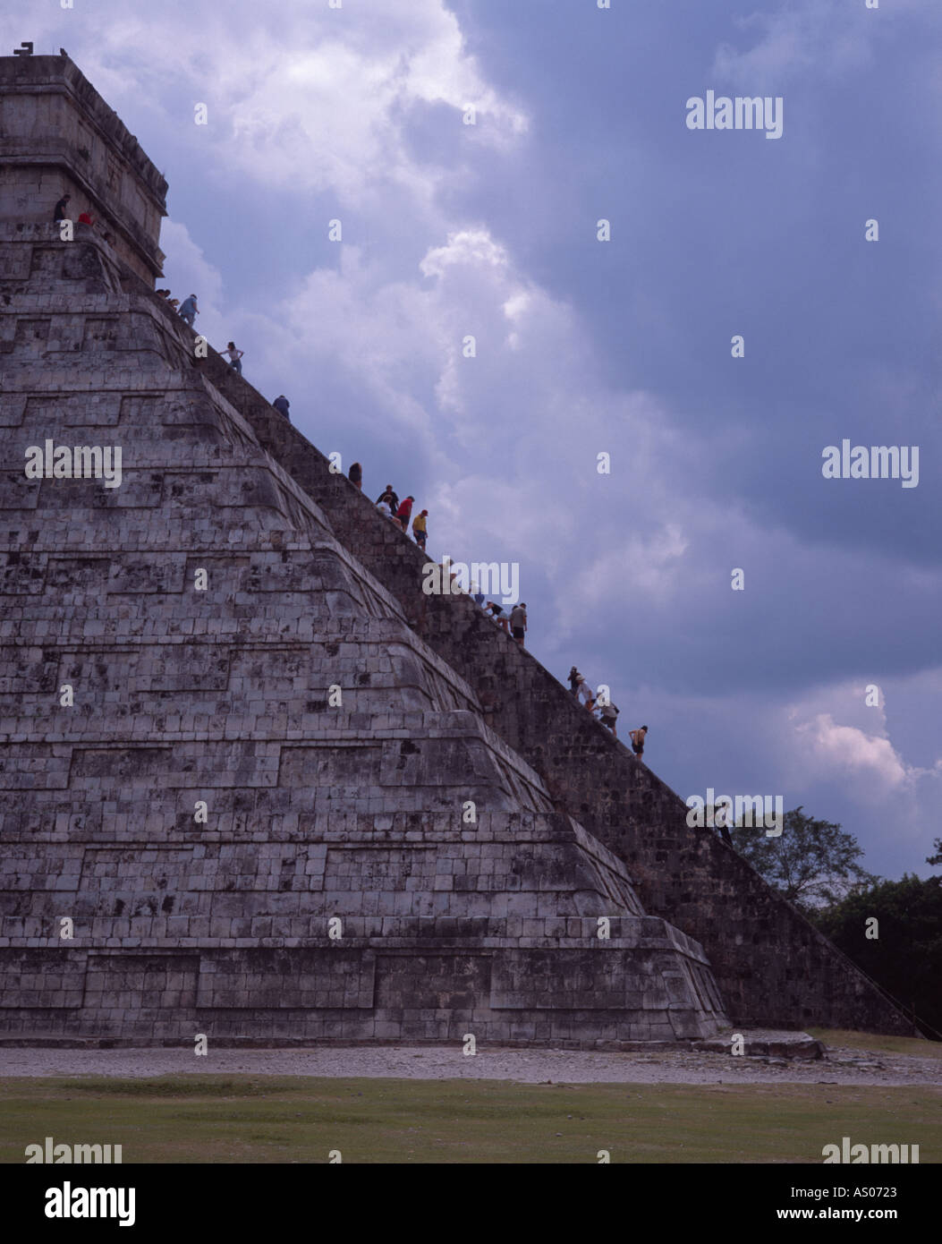 Tourists climbing the steep steps of the pyramid El Castillo Chichen