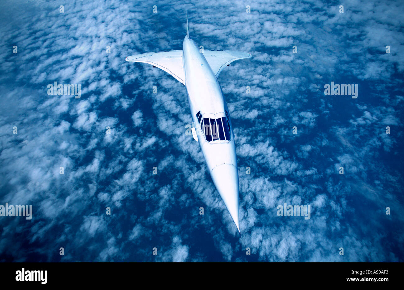 passenger aircraft Concorde flying at high altitude above cloud Stock Photo