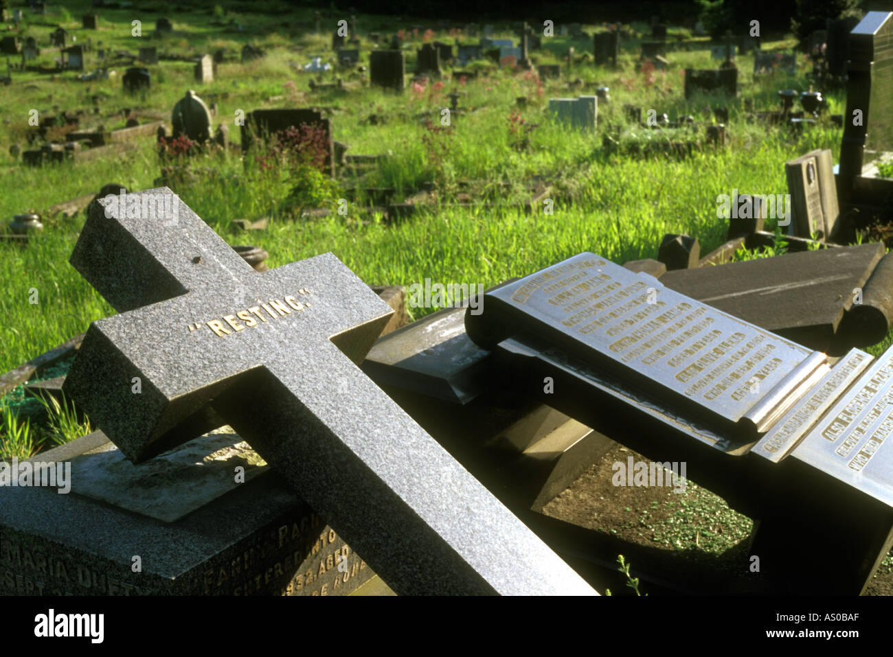 Fallen headstones with the word resting on one Stock Photo - Alamy