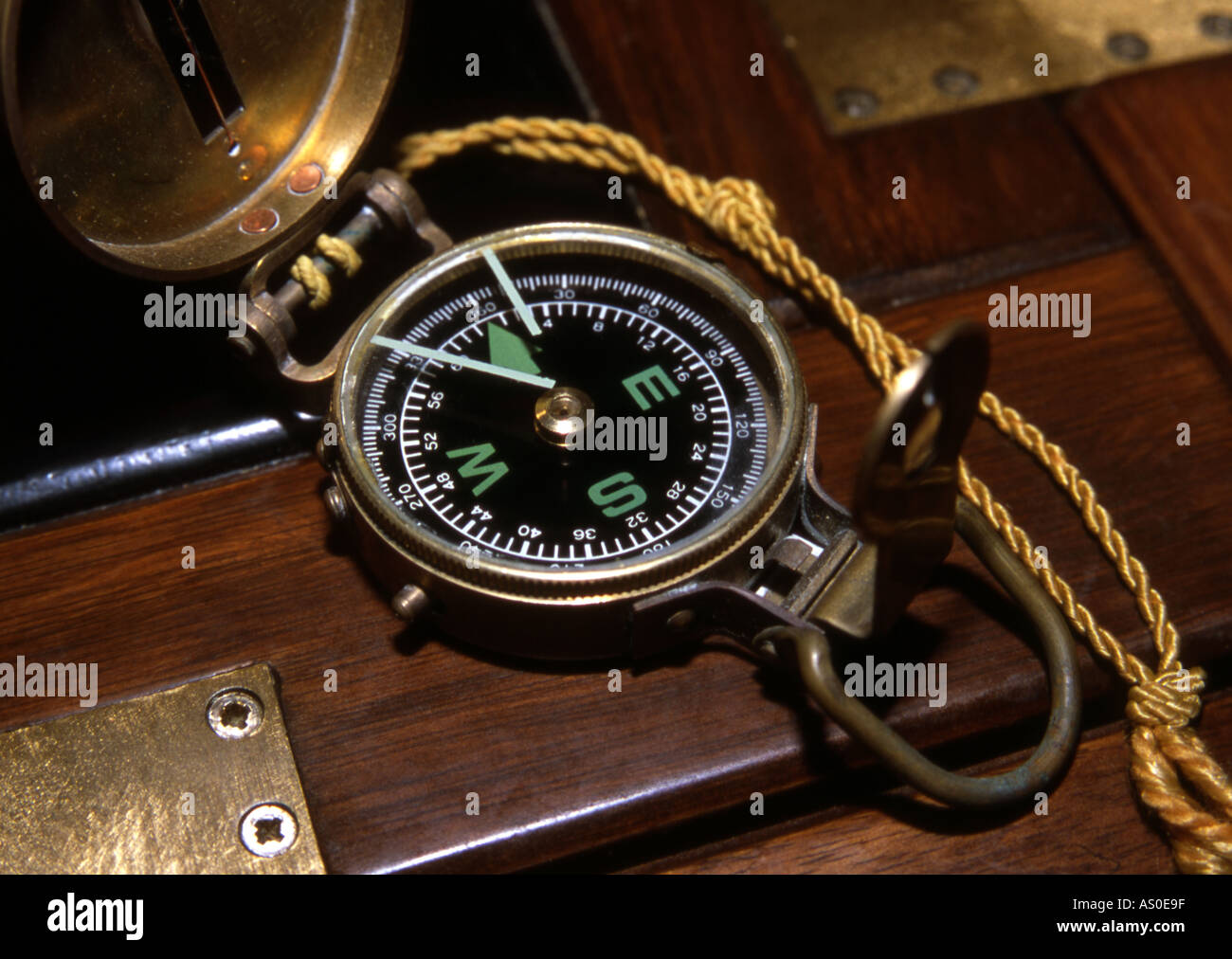 Antique brass compass on wooden table Stock Photo