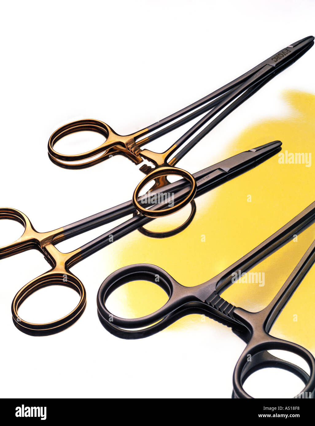 Surgical hemostat clamps on white and yellow background Stock Photo Alamy