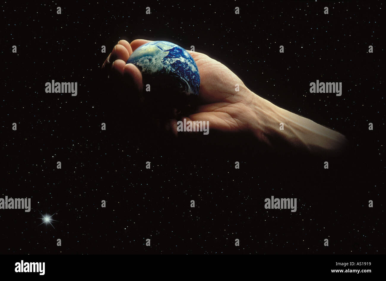 Symbolic picture of a Man's Hand holding the earth in Outer space, Conserving And protecting the planet Stock Photo