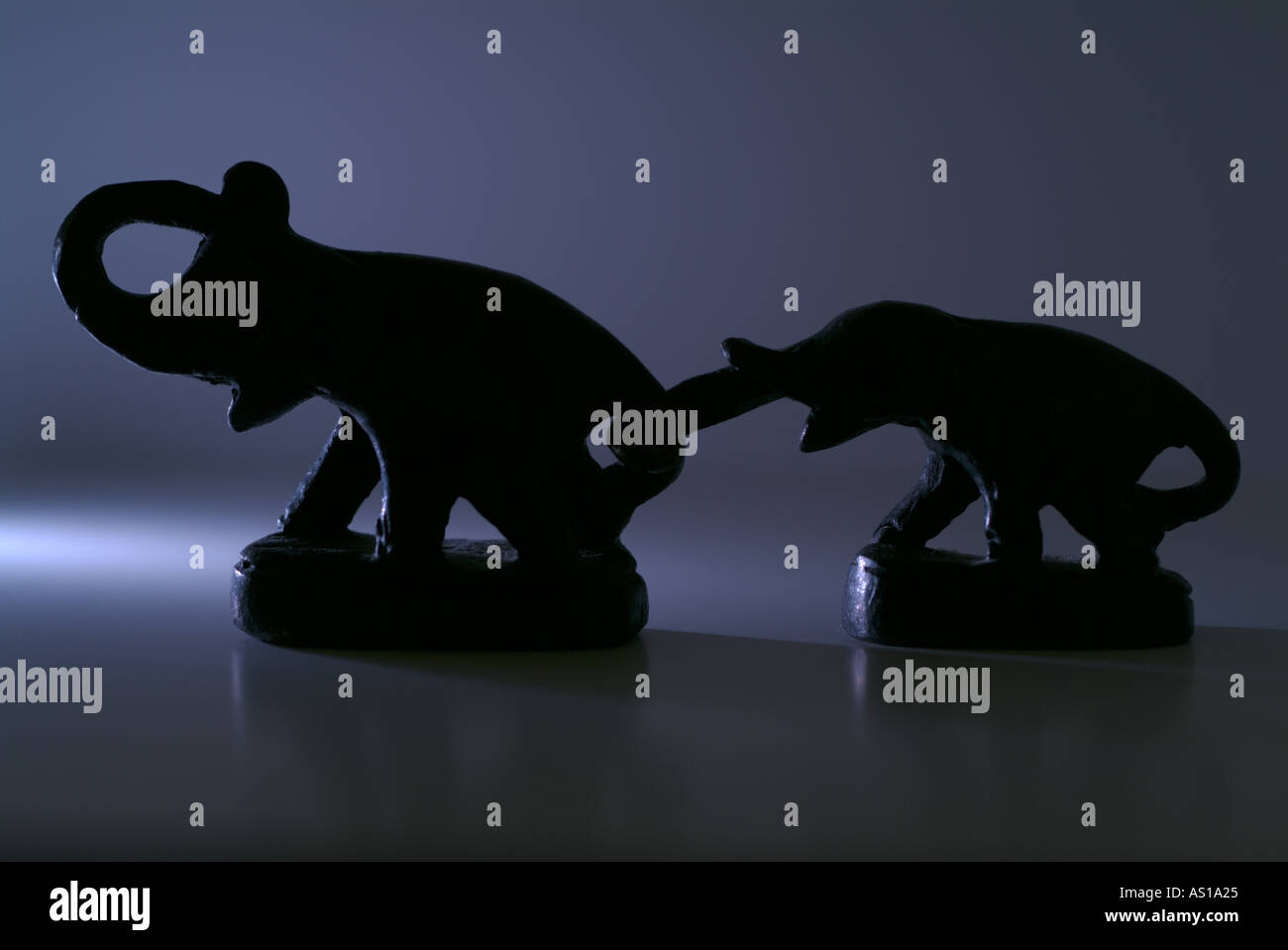 Statues of an elephant family attached each others with their trunks Stock Photo