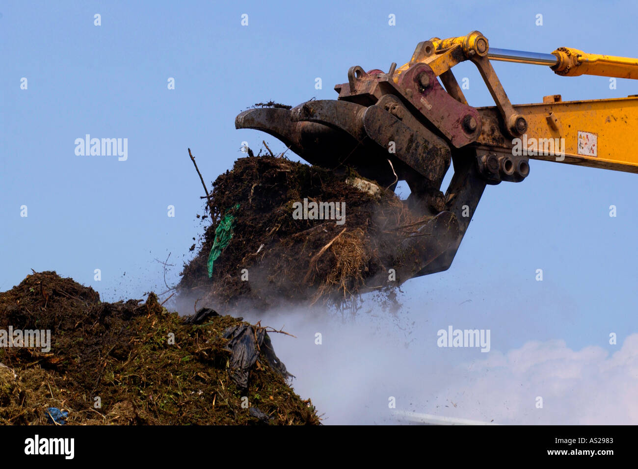 Domestic garden waste collected from houses being turned on a giant
