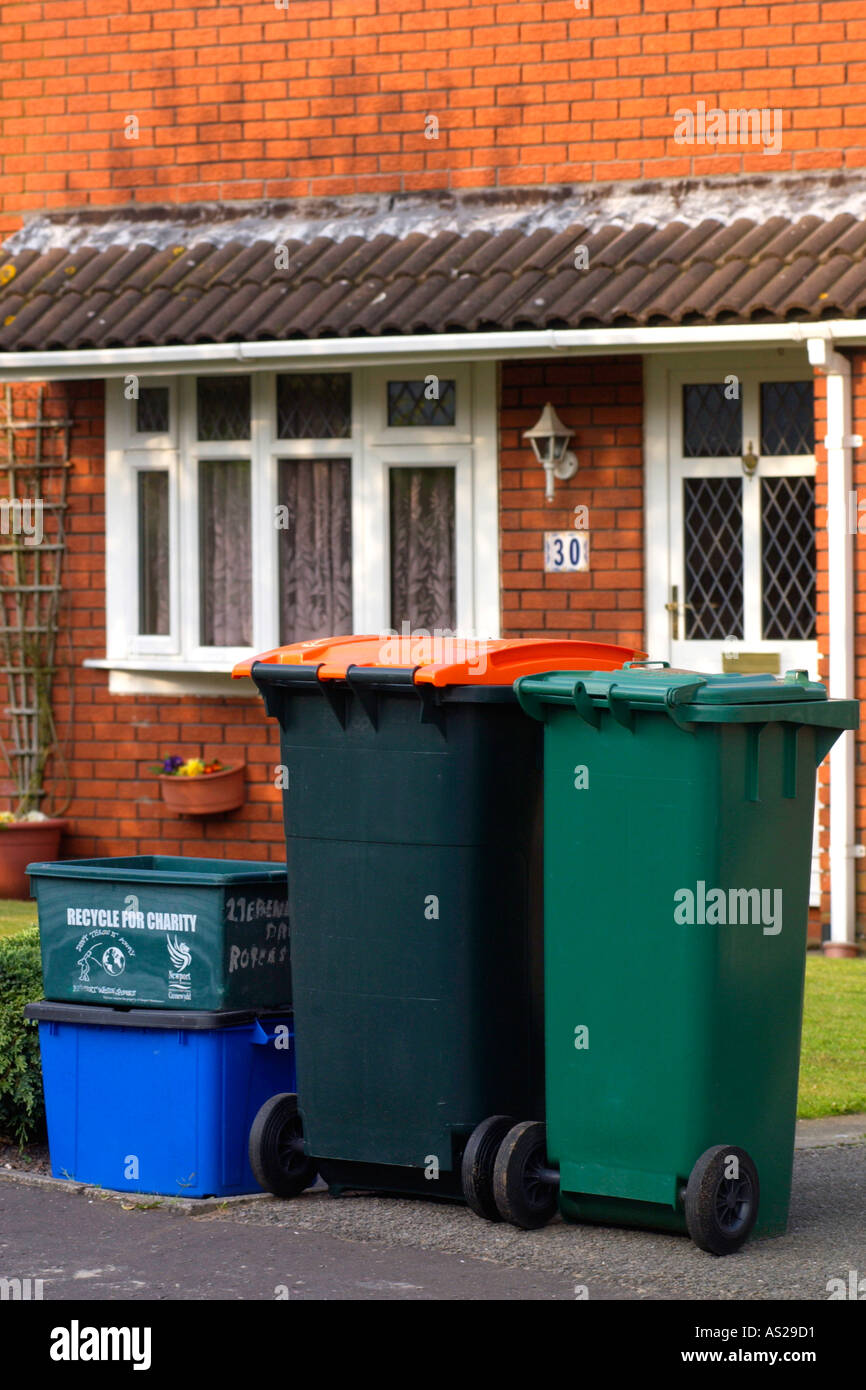 Boxes filled with material for recycling and wheelie bins full of domestic rubbish for landfill