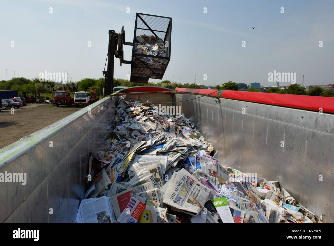 Newspapers collected for recycling by Newport Wastesavers in city of Newport South Wales UK being loaded into lorry Stock Photo