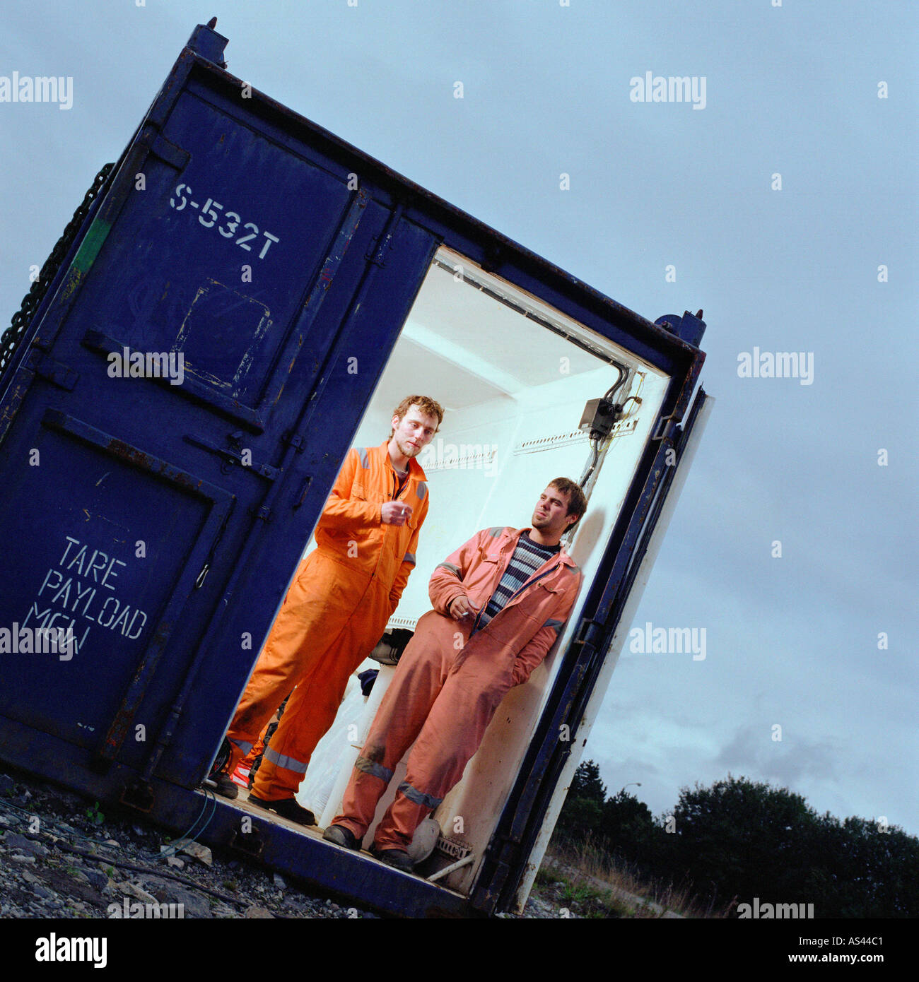 Construction workers in cargo container Stock Photo