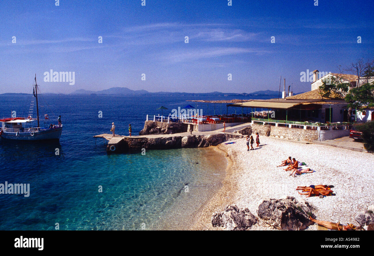 Corfu Greece Nissaki Beach People Sunbathing Boat Stock Photo