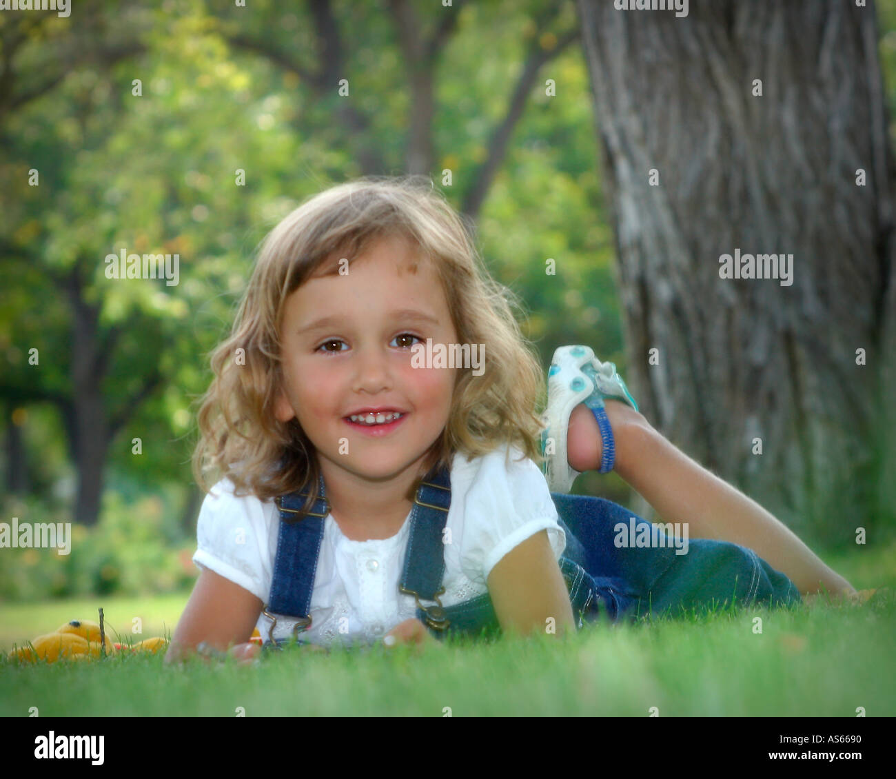 Happy little girl playing in a park Stock Photo - Alamy