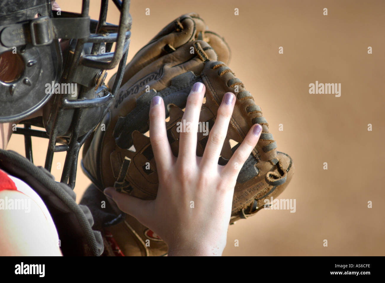 Young girl catching in real Fast Pitch Softball practice for the first