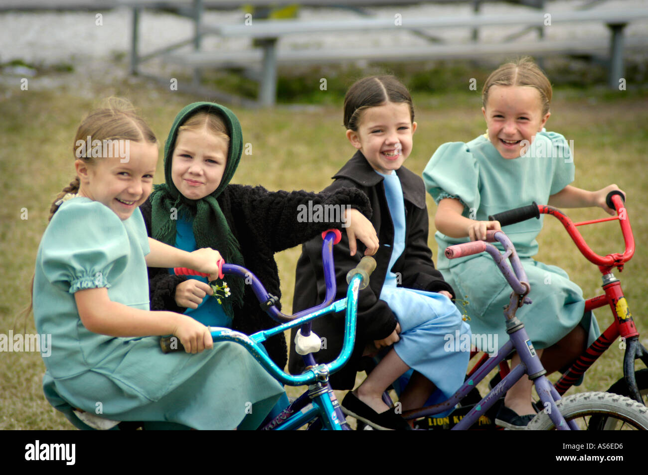 Amish Girls on Bikes watching the English at a park in Sarasota FL at the Pinecraft community of all Amish or Mennonites for winter get away Stock Photo