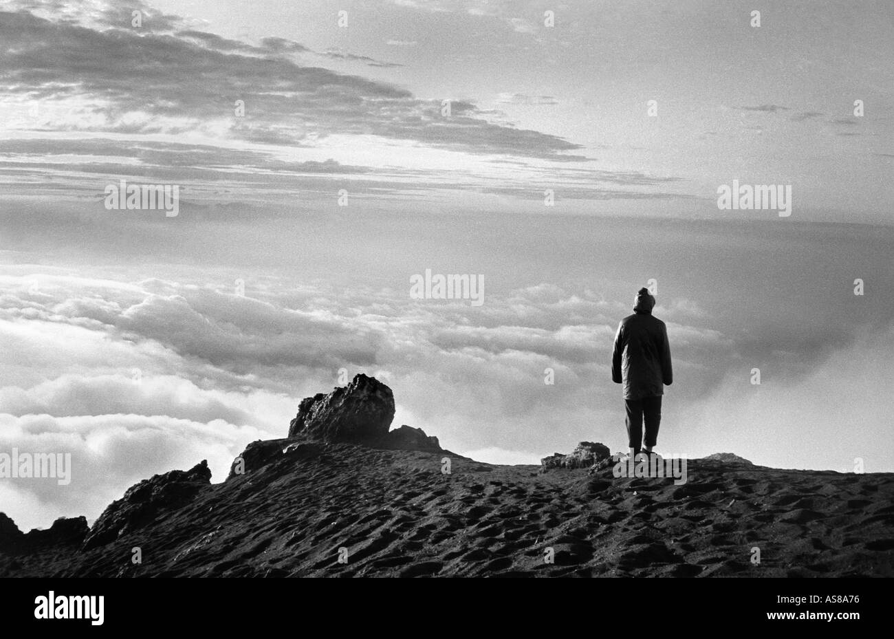 On top of the world View from the summit of Mount Merapi at Sunrise A solitary Silhouetted figure Central Java Indonesia Stock Photo