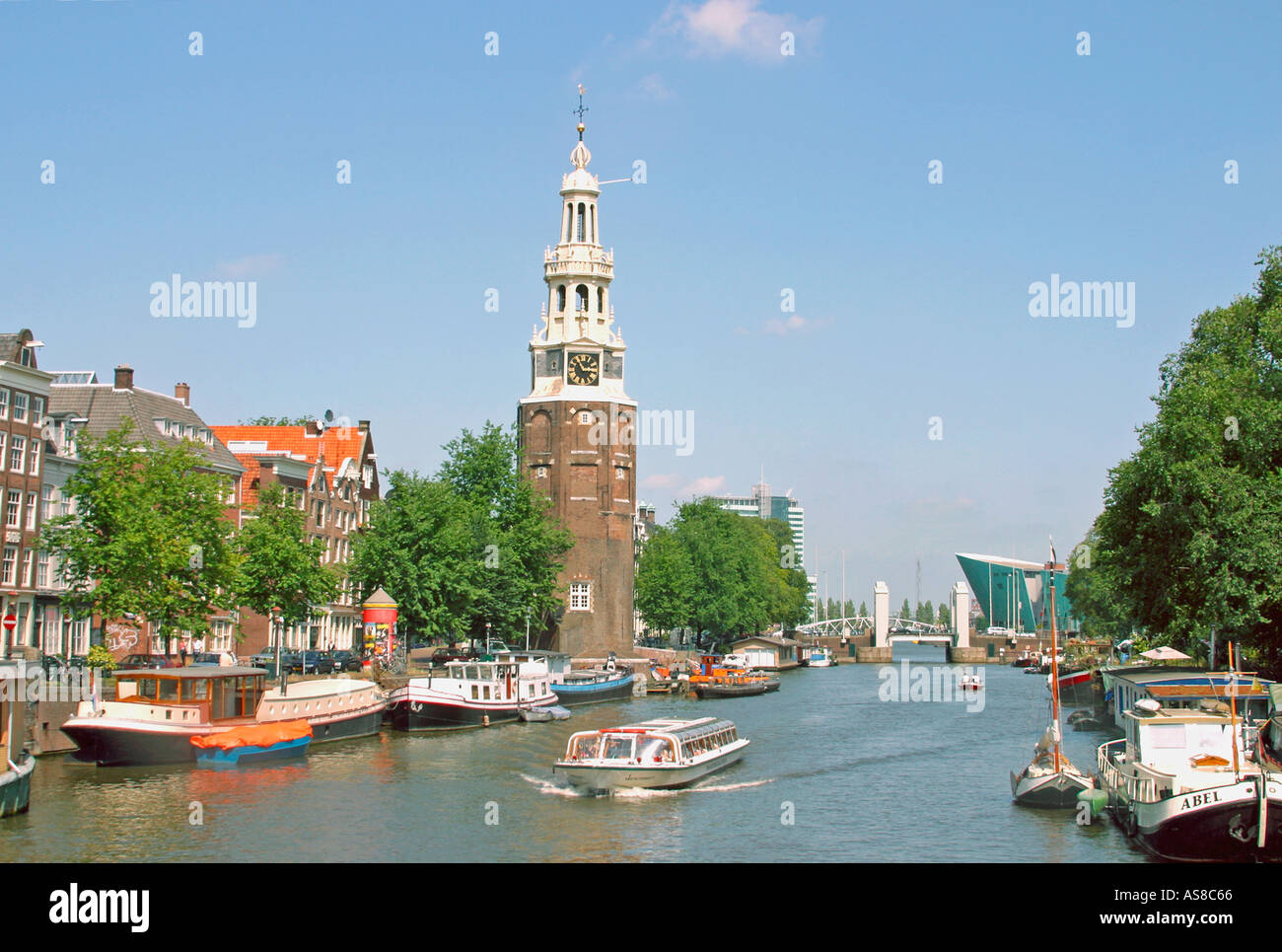 Amsterdam Holland Montelbaanstoren and excursion boat on Oudeschans canal Stock Photo
