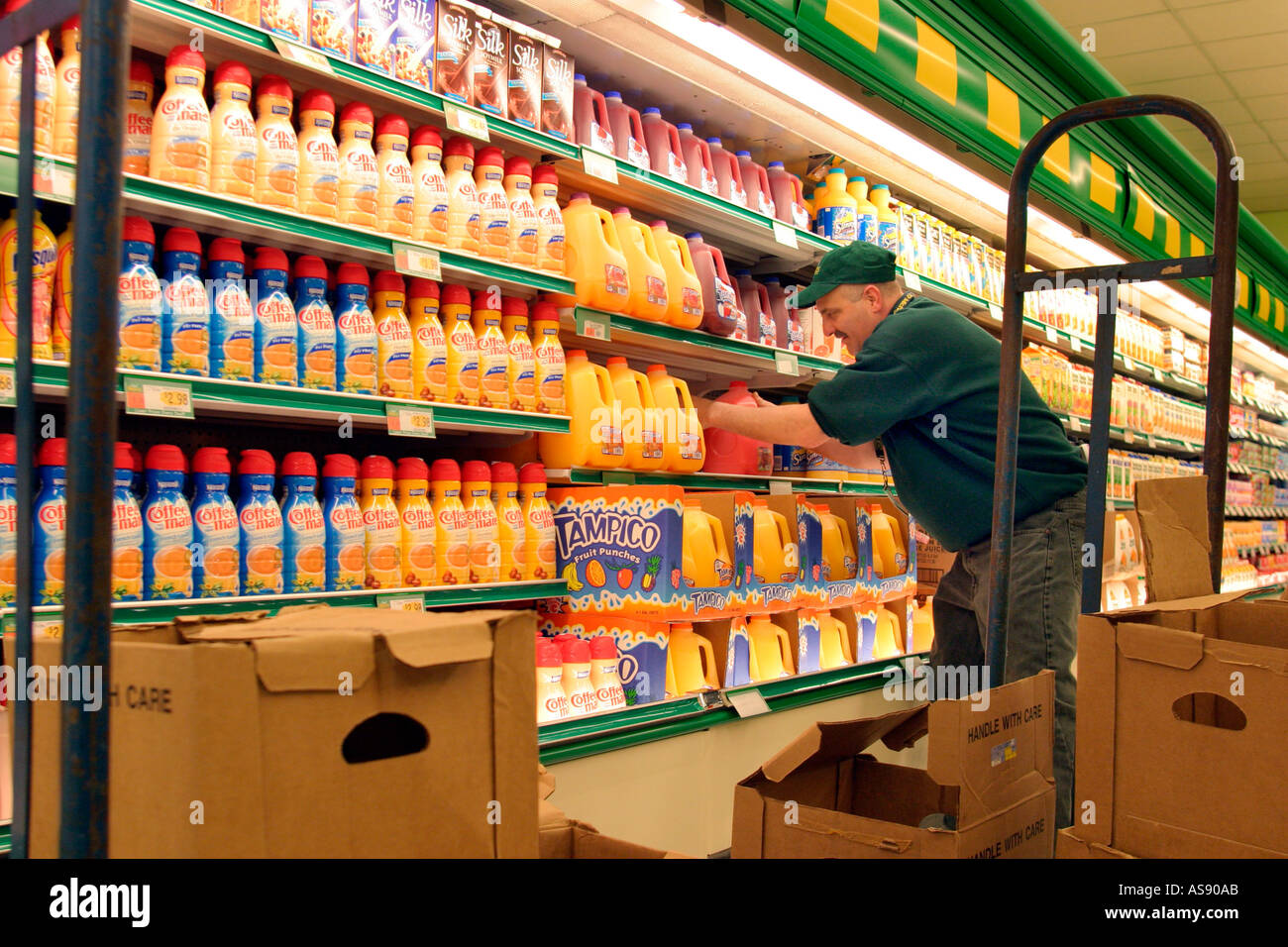 Worker stocks shelves at Food Basics supermarket Stock Photo Alamy