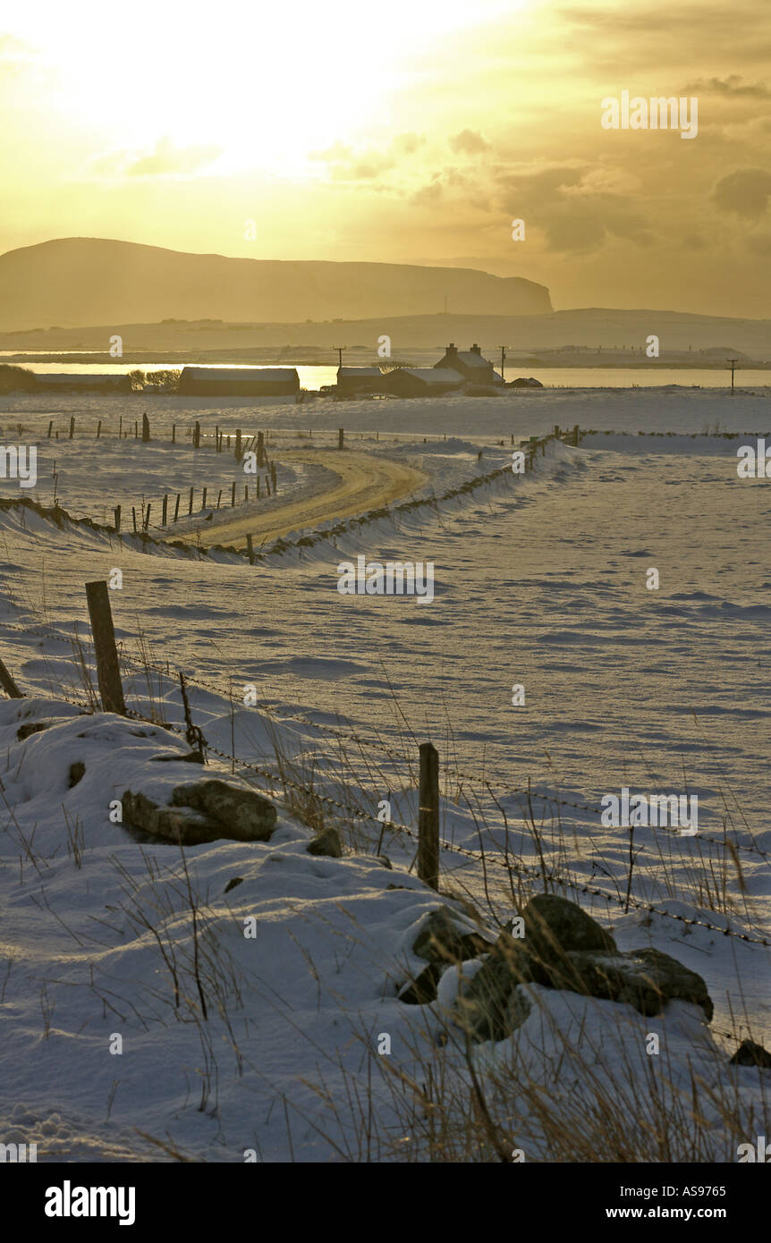 dh Loch of Harray HARRAY ORKNEY Bronze dusk snowy fields and house Loch Harray and Stenness Hoy hills Stock Photo