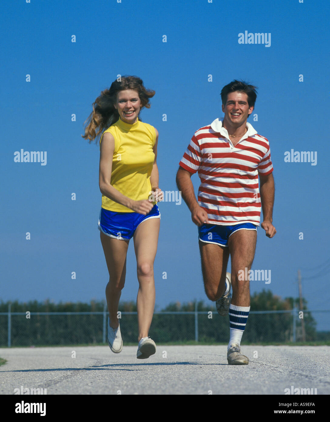 young couple jogging on running track Stock Photo