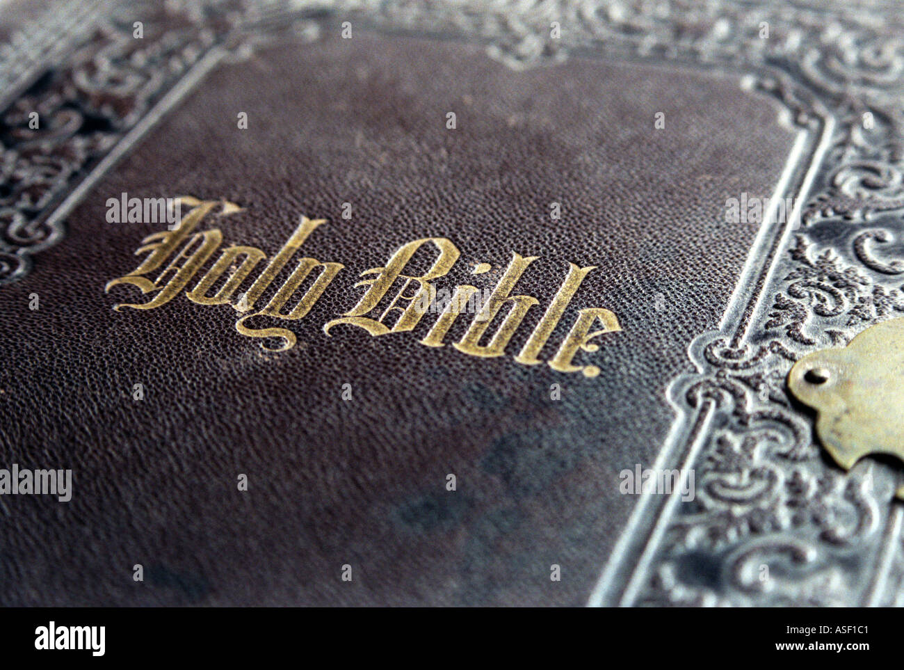 a close up of the leather bound cover of an old holy bible stock