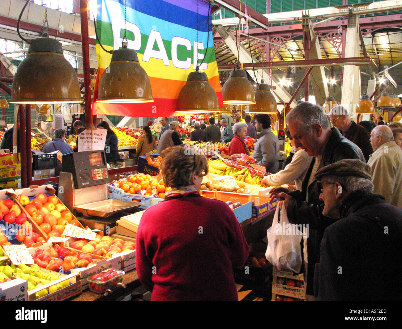 Peace flag hangs over produce in Florence Italy s Central Market Stock Photo
