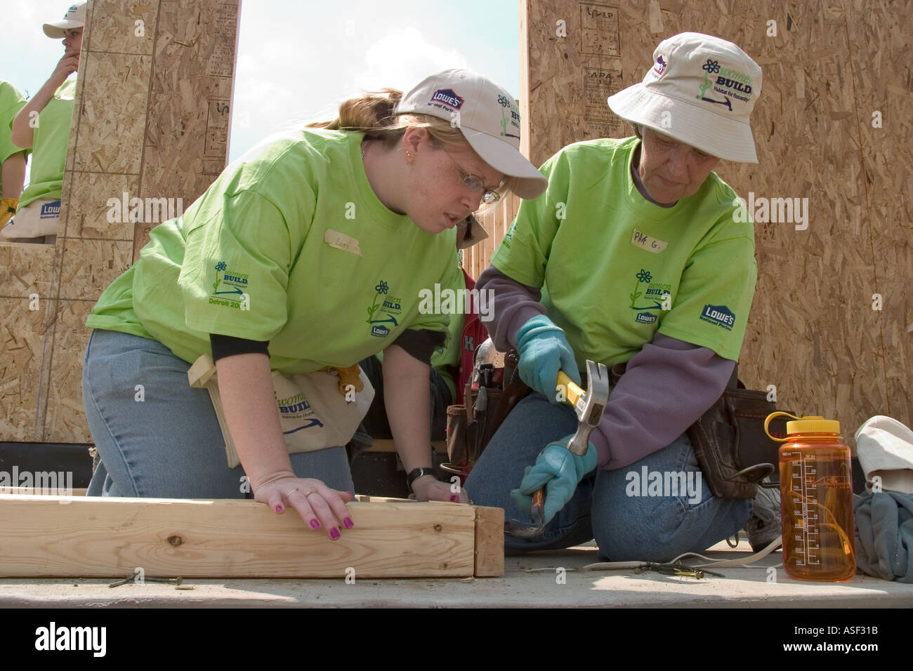 Women volunteers help build house for low family through Habitat for Humanity Stock Photo