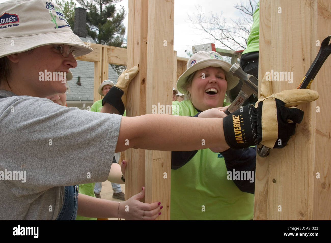 Women volunteers help build house for low family through Habitat for Humanity Stock Photo