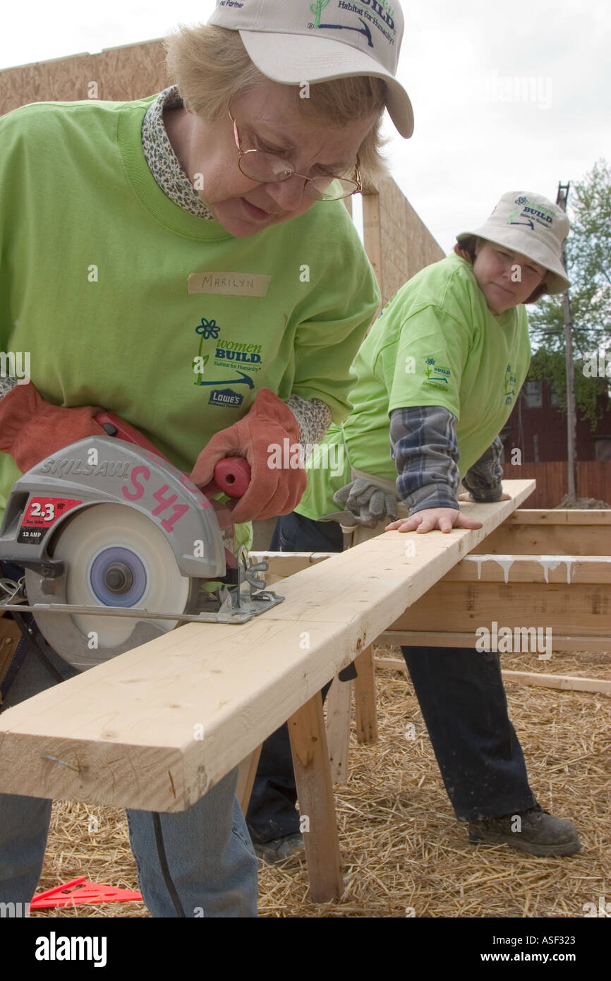 Women volunteers help build house for low family through Habitat for Humanity Stock Photo