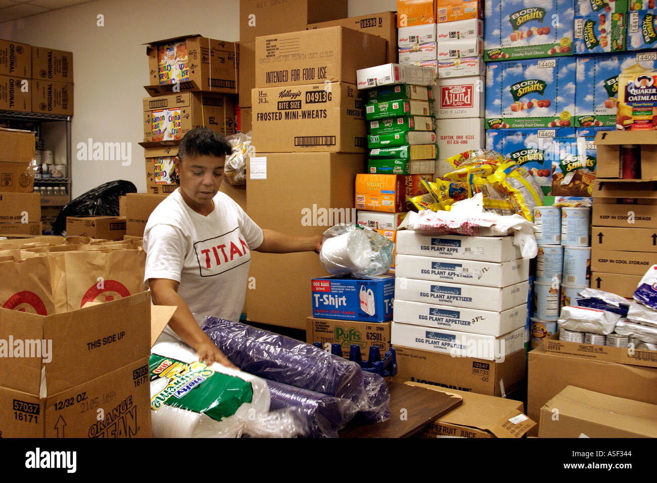 Worker at food pantry sorts food for distribution to low income residents of the Detroit area Stock Photo