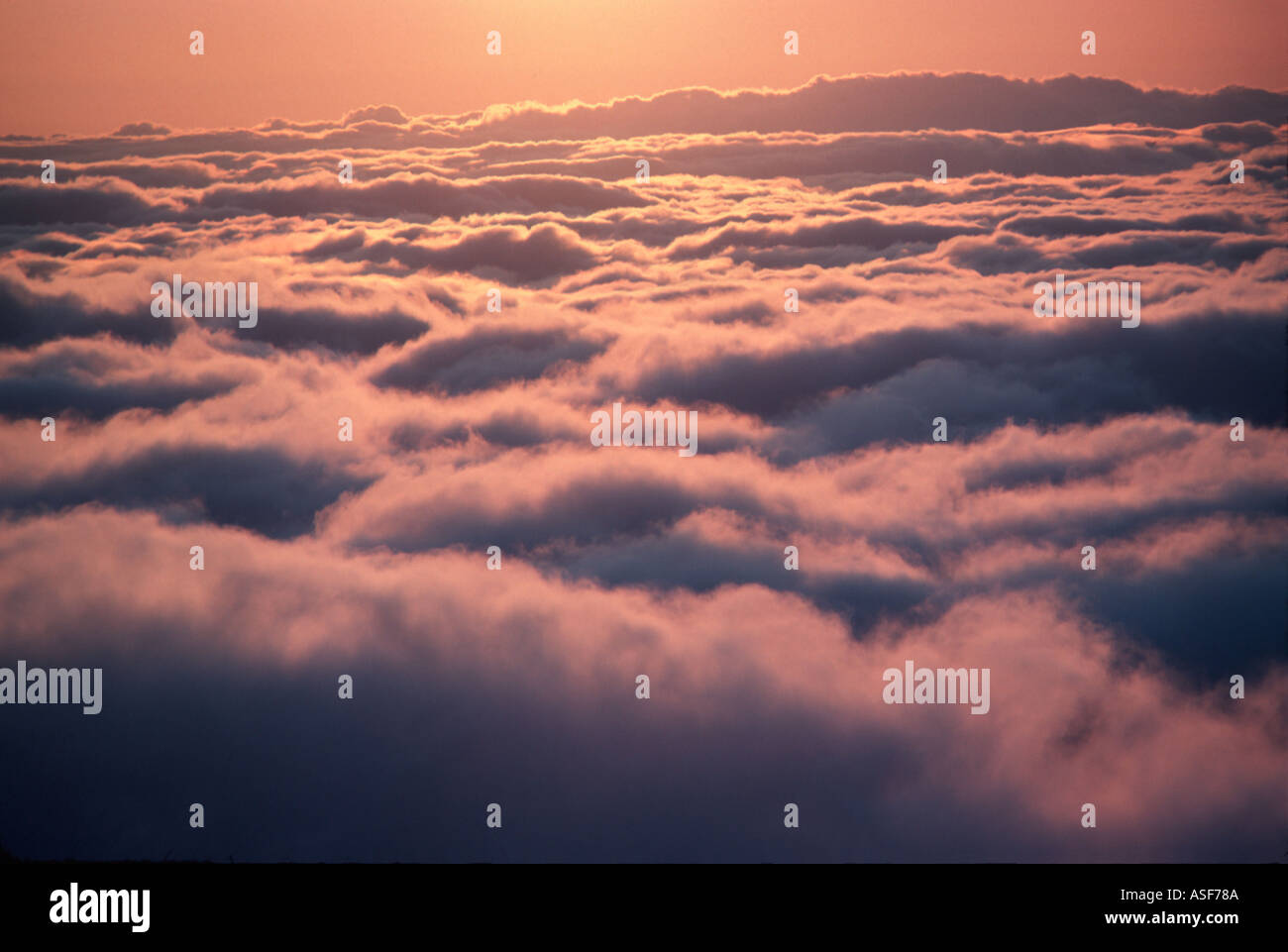 Sunset over clouds Stock Photo