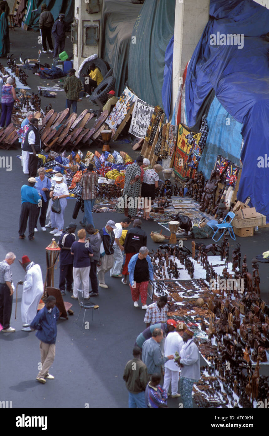 Tourists buying african arts and crafts at dockside market , Dakar , Senegal Stock Photo