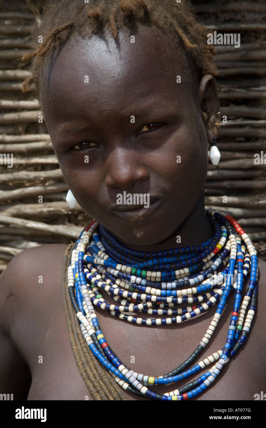 Teenage Girl with Mud on her Chin and an Attitude of the Dhasanech Tribe, Omo River Valley Delta, Ethiopia Stock Photo