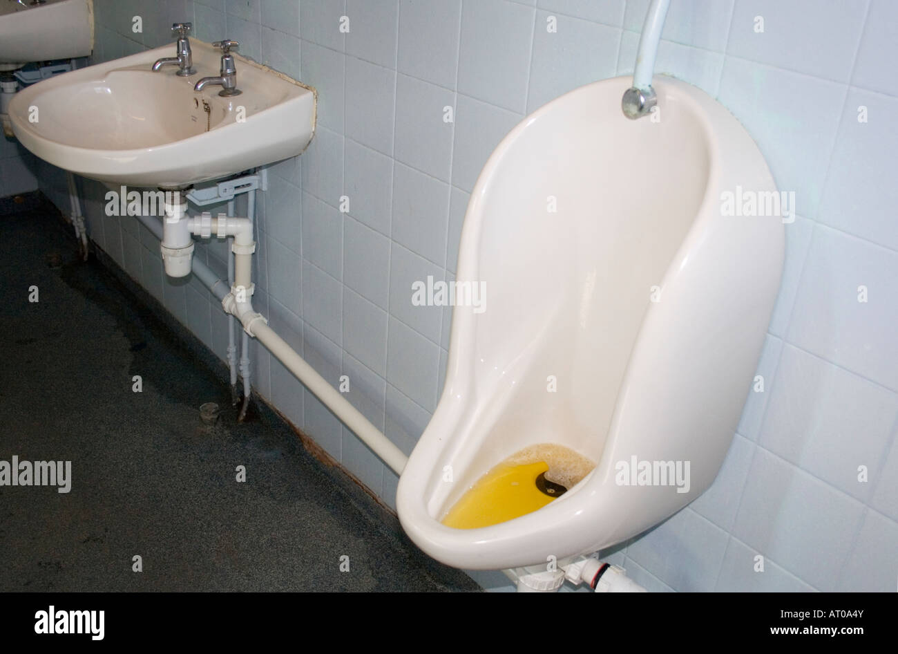 Blocked urinal in a gents public lavatory. UK Stock Photo Alamy