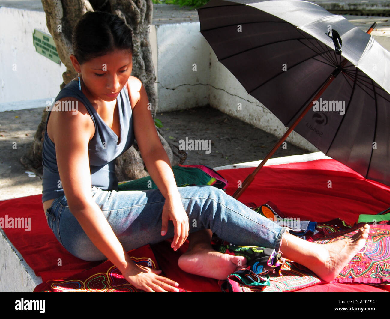 Young Kuna woman arranges her molas for selling to the tourists Stock Photo