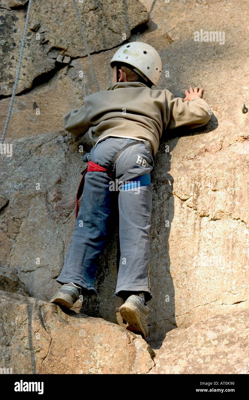 little boy male climbing a rock Stock Photo Alamy