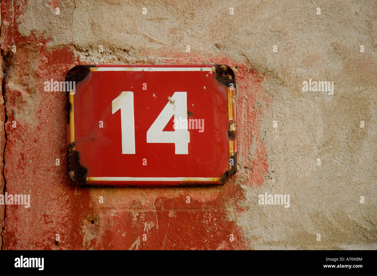 DOOR NUMBER FOURTEEN 14 ON A OLD WALL BACKGROUND Stock Photo