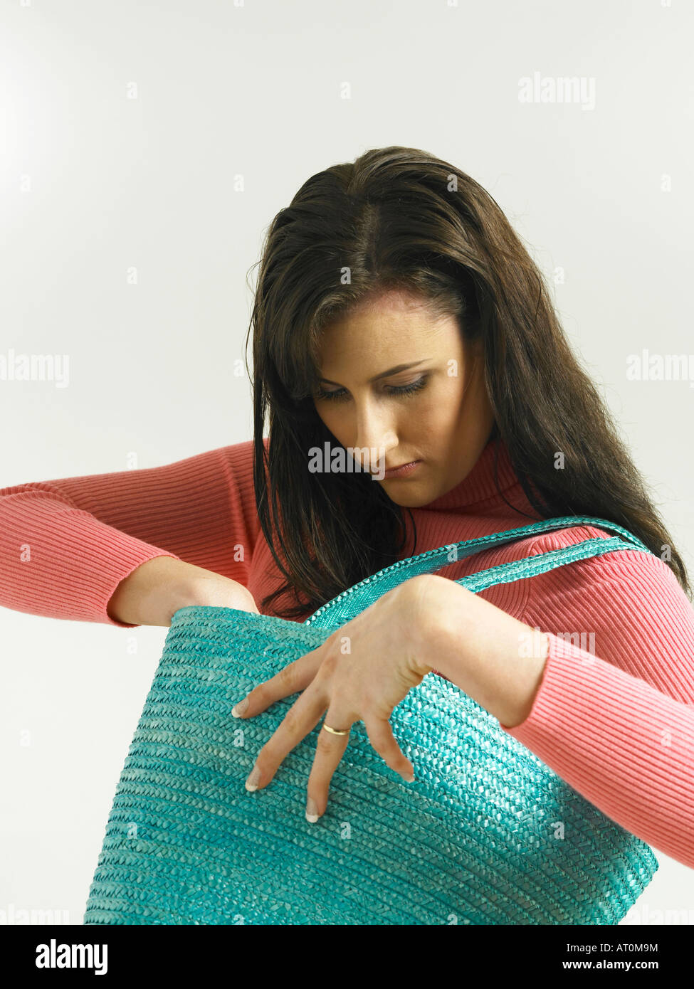 woman taking something out from her bag Stock Photo Alamy