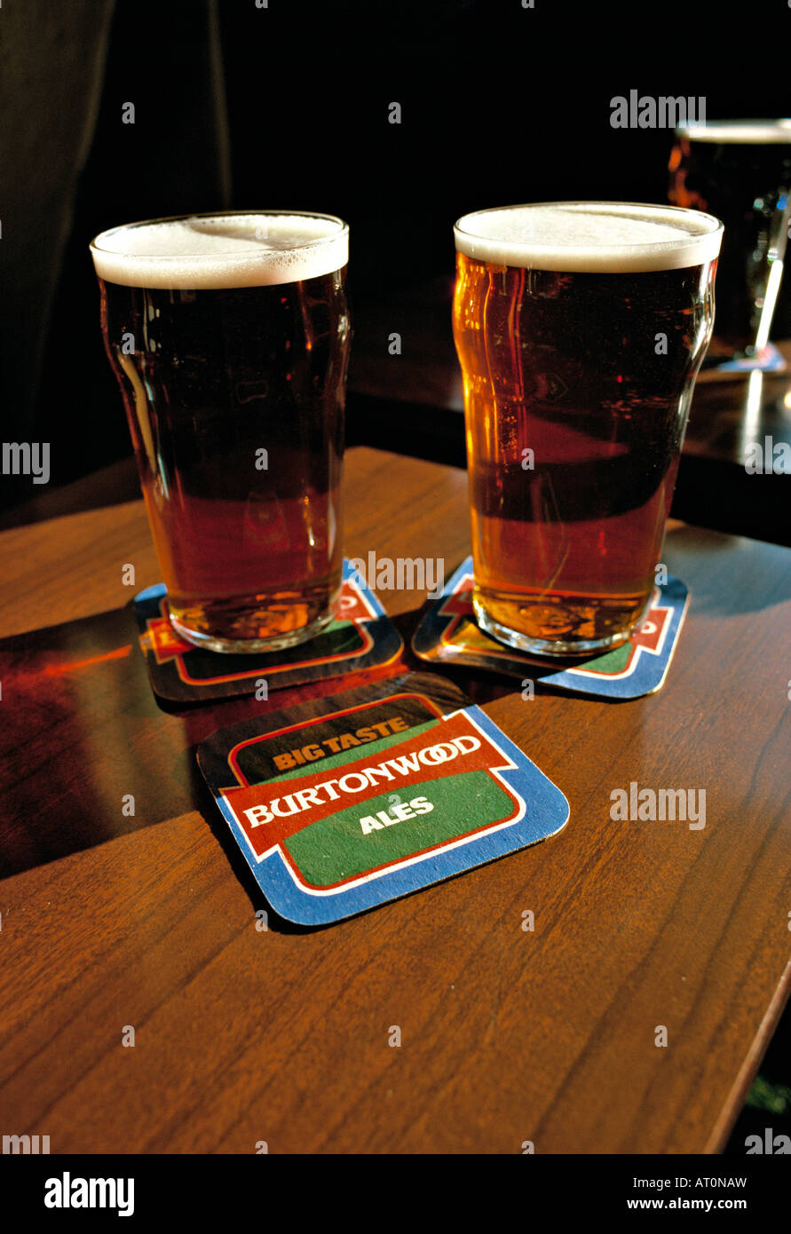 Two pints of beer on pub table with beer mats, Wales, 1980s Stock Photo
